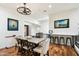Open dining area with wood floors, stylish lighting, and a breakfast bar, perfect for entertaining at 5630 E Peak View Rd, Cave Creek, AZ 85331