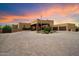 A beautiful exterior elevation of this property with a circular driveway and manicured landscaping at 5630 E Peak View Rd, Cave Creek, AZ 85331