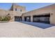 Exterior view of a spacious three-car garage with a brick-paved driveway at 5630 E Peak View Rd, Cave Creek, AZ 85331