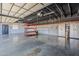 Spacious three-car garage featuring block wall construction, painted walls and ceiling, and organized storage at 5630 E Peak View Rd, Cave Creek, AZ 85331