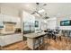A kitchen with white cabinets, stainless steel appliances, hardwood floors, and an eat-in island at 5630 E Peak View Rd, Cave Creek, AZ 85331