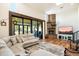 Inviting living room featuring a cozy fireplace, ample seating, and expansive sliding glass doors to the backyard at 5630 E Peak View Rd, Cave Creek, AZ 85331