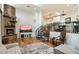 Stylish living room with a brick fireplace, modern decor, and an open layout with views of the kitchen at 5630 E Peak View Rd, Cave Creek, AZ 85331