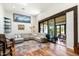 Bright living room with a large sectional sofa, hardwood floors, and sliding glass doors to the outdoors at 5630 E Peak View Rd, Cave Creek, AZ 85331