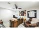 Comfortable home office with a wooden desk, leather chair, and sports memorabilia at 5630 E Peak View Rd, Cave Creek, AZ 85331