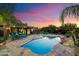 Beautiful backyard oasis featuring a pool, waterfall, and outdoor lounge area at 5630 E Peak View Rd, Cave Creek, AZ 85331