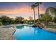 An amazing backyard oasis with a pool, waterfall, and relaxing lounge seating at 5630 E Peak View Rd, Cave Creek, AZ 85331