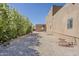 Gravel side yard with lush, flowering trees, showing the house exterior, privacy and ample space at 5630 E Peak View Rd, Cave Creek, AZ 85331