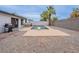 This backyard features a pool, grill, patio seating area, desert landscaping and privacy wall at 5817 S Siesta Ln, Tempe, AZ 85283