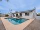 This backyard features a pool, grill, patio seating area, desert landscaping and privacy wall at 5817 S Siesta Ln, Tempe, AZ 85283