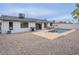 This backyard features a pool, grill, patio seating area, desert landscaping and privacy wall at 5817 S Siesta Ln, Tempe, AZ 85283