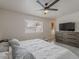 Bright bedroom with a ceiling fan and a window that lets in plenty of natural light at 5817 S Siesta Ln, Tempe, AZ 85283