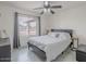 Cozy bedroom featuring a window with curtains, a ceiling fan, and a sleek bed frame at 5817 S Siesta Ln, Tempe, AZ 85283