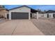 Inviting home showcasing a garage, desert landscaping, and a well-maintained front yard at 5817 S Siesta Ln, Tempe, AZ 85283