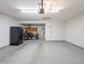 Spacious garage with white brick wall, epoxy floor, refrigerator and plenty of storage at 5817 S Siesta Ln, Tempe, AZ 85283