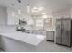 Stylish kitchen featuring stainless steel appliances, a breakfast bar, and elegant lighting fixtures at 5817 S Siesta Ln, Tempe, AZ 85283