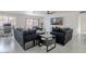 Comfortable living room with modern sofas, ceiling fan, and sliding glass doors to the outside at 5817 S Siesta Ln, Tempe, AZ 85283