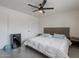 Bright bedroom with a ceiling fan, modern bed, and convenient mini-fridge at 5817 S Siesta Ln, Tempe, AZ 85283