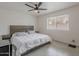 Serene main bedroom featuring a comfortable bed, side tables, and a large window at 5817 S Siesta Ln, Tempe, AZ 85283