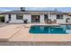 This backyard features a pool, grill, patio seating area, desert landscaping and privacy wall at 5817 S Siesta Ln, Tempe, AZ 85283