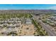 Expansive aerial view of the neighborhood featuring a community garden, scenic mountain views, and desert landscaping at 6550 S 24Th Pl, Phoenix, AZ 85042