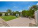 Spacious backyard with a lush lawn, playhouse, and privacy landscaping at 6550 S 24Th Pl, Phoenix, AZ 85042