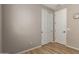Neutral bedroom with a bi-fold closet, stylish door, and sleek wood-look floors at 6550 S 24Th Pl, Phoenix, AZ 85042