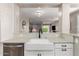 Bright kitchen featuring white cabinetry, quartz countertops, and a modern farmhouse sink at 6550 S 24Th Pl, Phoenix, AZ 85042