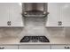 Stylish kitchen with stainless steel cooktop, pristine countertops, and ample storage in white cabinets at 6550 S 24Th Pl, Phoenix, AZ 85042