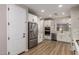 Spacious kitchen with stainless steel appliances, white cabinets, and wood-look tile flooring, ideal for culinary enthusiasts at 6550 S 24Th Pl, Phoenix, AZ 85042