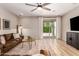 Cozy living room with sliding glass doors to backyard and comfortable leather sofa at 6550 S 24Th Pl, Phoenix, AZ 85042