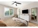 Bright main bedroom featuring neutral tones, large window, and comfortable furniture at 6550 S 24Th Pl, Phoenix, AZ 85042