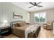 Comfortable main bedroom with wood panel accent wall and large window at 6550 S 24Th Pl, Phoenix, AZ 85042