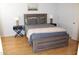 A well-lit bedroom has a wooden bed frame, coordinated nightstands, and light wood floors at 7120 E Wilshire Dr # 10, Scottsdale, AZ 85257