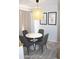 A cozy dining area features a round white table with gray chairs and a decorative pendant light at 7120 E Wilshire Dr # 10, Scottsdale, AZ 85257