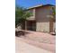 Two-story condo with a patio, desert landscaping, and gravel ground cover at 7120 E Wilshire Dr # 10, Scottsdale, AZ 85257