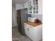 This kitchen showcases stainless steel appliances, wooden countertops, and white cabinetry for a clean, modern look at 7120 E Wilshire Dr # 10, Scottsdale, AZ 85257