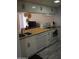 An inviting kitchen with stainless steel sink, wooden countertops, and white cabinets for a bright, modern feel at 7120 E Wilshire Dr # 10, Scottsdale, AZ 85257
