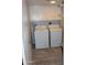 Efficient laundry room featuring a side-by-side washer and dryer and overhead white cabinets at 7120 E Wilshire Dr # 10, Scottsdale, AZ 85257