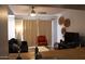 The living room features a comfortable sofa, an accent chair, and sliding glass doors for natural light at 7120 E Wilshire Dr # 10, Scottsdale, AZ 85257