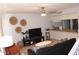Cozy living room with modern decor, a ceiling fan, and an open breakfast bar at 7120 E Wilshire Dr # 10, Scottsdale, AZ 85257