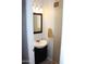 Charming powder room featuring a black vanity with a modern mirror, a decorative light, and stylish fixtures at 7120 E Wilshire Dr # 10, Scottsdale, AZ 85257
