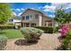 Lush backyard with artificial turf, mature landscaping, and a shaded patio area at 7456 W Via Montoya Dr, Glendale, AZ 85310
