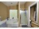Relaxing bathroom featuring a soaking tub and separate glass-enclosed shower at 7456 W Via Montoya Dr, Glendale, AZ 85310