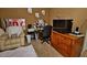 Cozy bedroom featuring a comfortable armchair and wooden cabinet at 7456 W Via Montoya Dr, Glendale, AZ 85310
