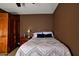Comfortable bedroom with warm brown walls and ample closet space for a cozy retreat at 7456 W Via Montoya Dr, Glendale, AZ 85310