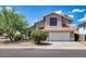 Charming two-story home featuring a well-manicured front yard and a two car garage at 7456 W Via Montoya Dr, Glendale, AZ 85310
