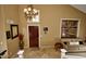 Elegant foyer with high ceilings, chandelier, and stylish travertine tile flooring at 7456 W Via Montoya Dr, Glendale, AZ 85310