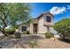 Inviting home exterior features a well-maintained landscape, mature trees, and a two-car garage at 7456 W Via Montoya Dr, Glendale, AZ 85310