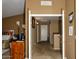 Neutral hallway leading past office with built-in desk, and tan walls and brown carpet at 7456 W Via Montoya Dr, Glendale, AZ 85310